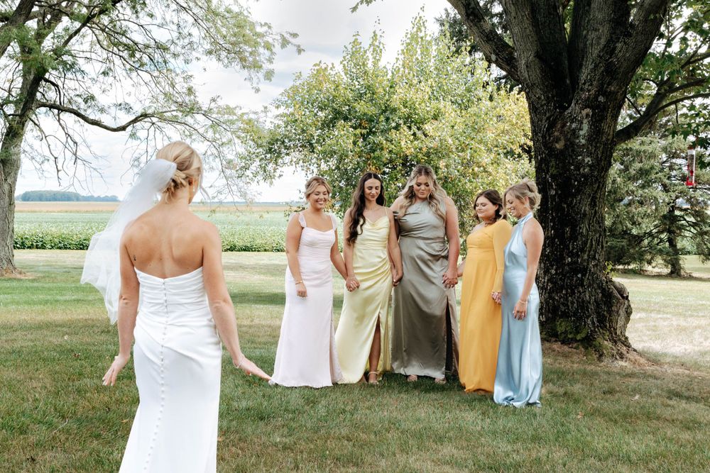 Bridesmaids first look with bride photos captured by photographer Autumn Case with DreamStudios LLC out of Toledo ohio