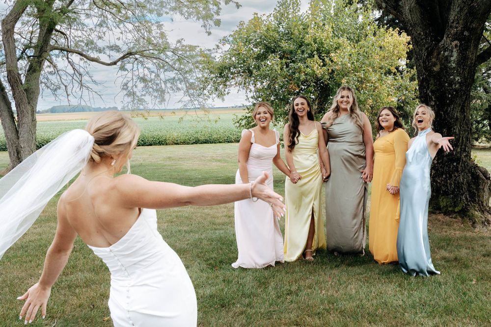 Bridesmaids first look with bride photos captured by photographer Autumn Case with DreamStudios LLC out of Toledo ohio