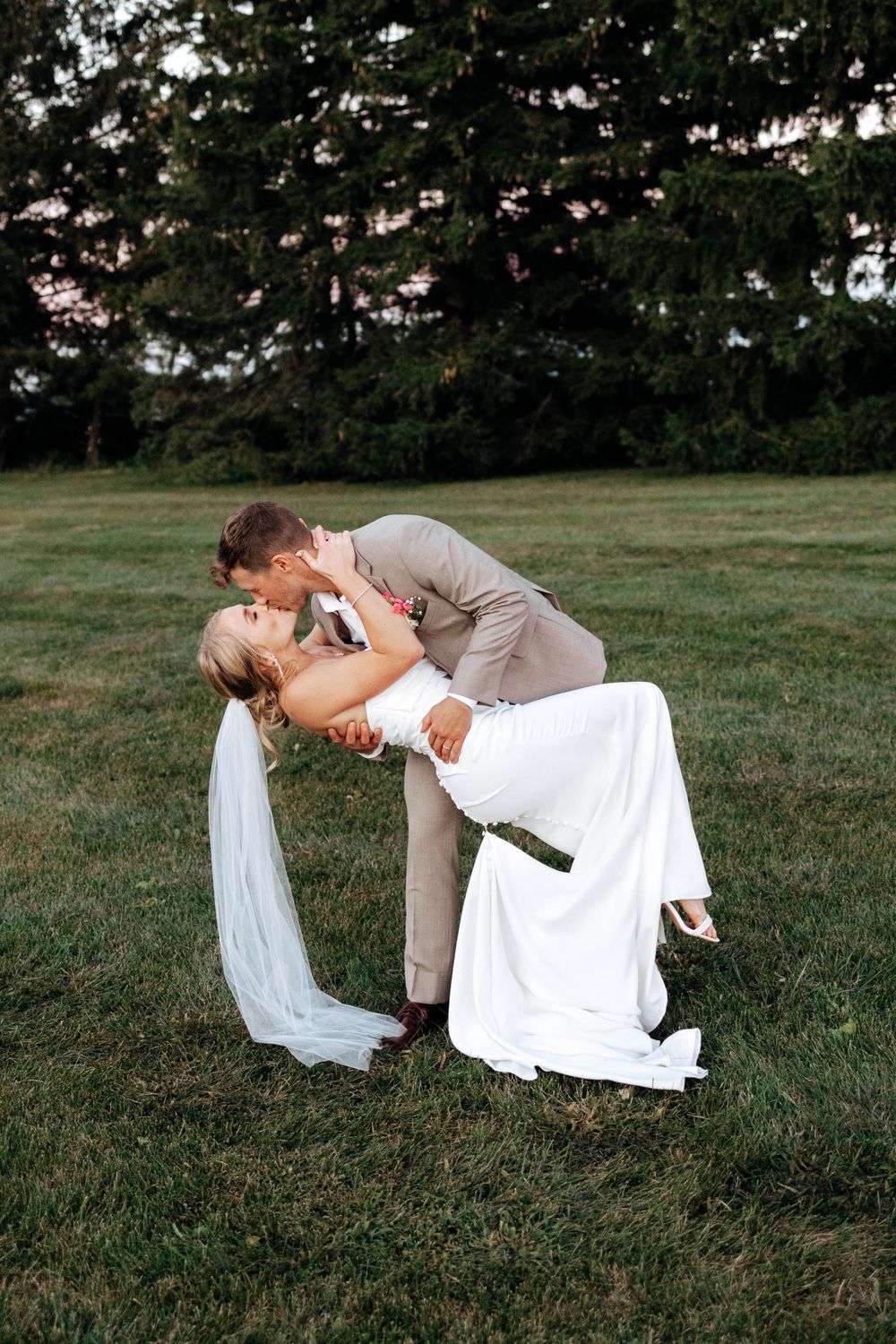 bride and groom poses with veil in Ohio