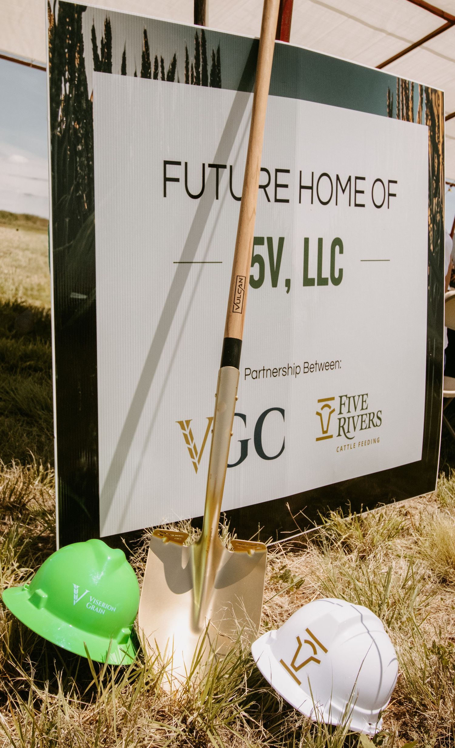 Groundbreaking sign for Future Home of 5V LLC, a partnership between VGC and Five Rivers Cattle Feeding, with hard hats and shovel.
