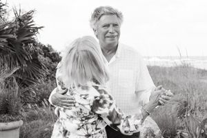 Husband and wife embracing among greenery for anniversary portraits in black and white photo with Lindy Rebro Photography