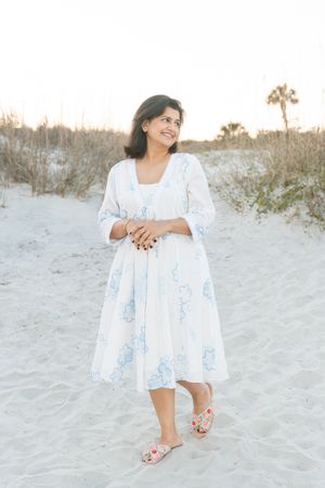 Outdoor anniversary portrait of a woman during her couple's portrait session in warm evening light