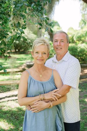 Anniversary photos of a couple beneath Spanish moss