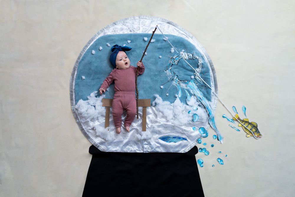 Artistic illustration of figure on a swing breaking through a snow globe wall with blue water splash effects.
