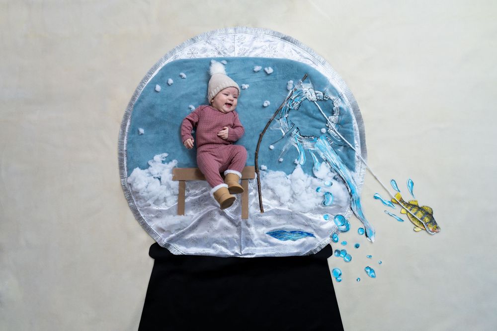 Creative conceptual photo illustration of a winter snow globe featuring a figure on a ski lift with water splashing out.