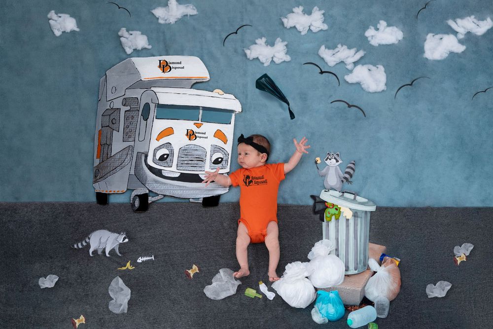 Small boy with orange shirt helps clean garbage next to a food truck while birds circle overhead in an illustration.