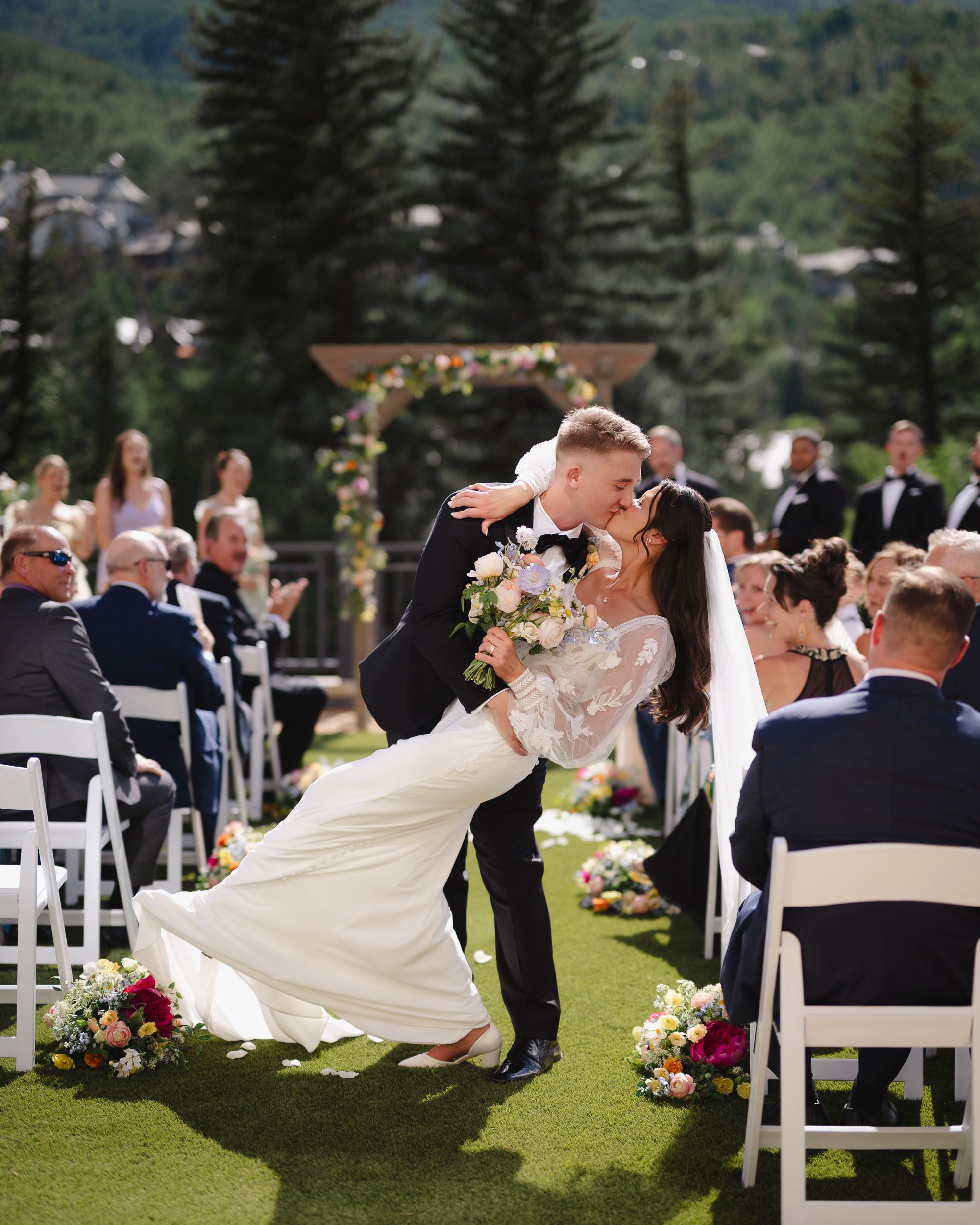 Five aligned images show a beautiful outdoor wedding ceremony featuring guests seated in white chairs on a lush green lawn.