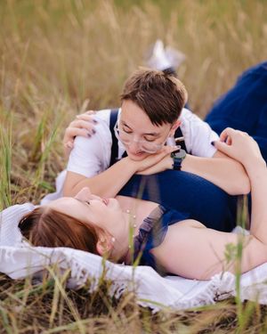 Tender moments shared while lying in a sunny meadow.