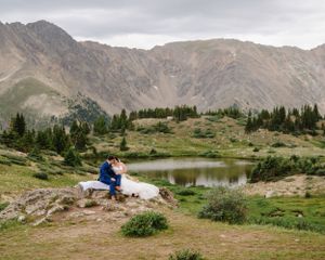 Mountain lake wedding portraits with majestic alpine landscape.