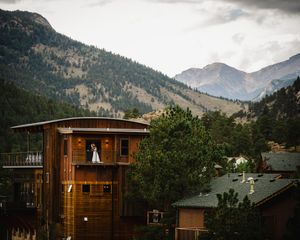 Mountain landscape with wooden buildings nestled against dramatic peaks.