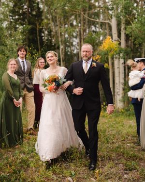 Wedding party celebrating in a beautiful aspen grove during autumn.