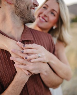 Close-up series of hands tenderly touching in a romantic gesture against a blurred outdoor background.