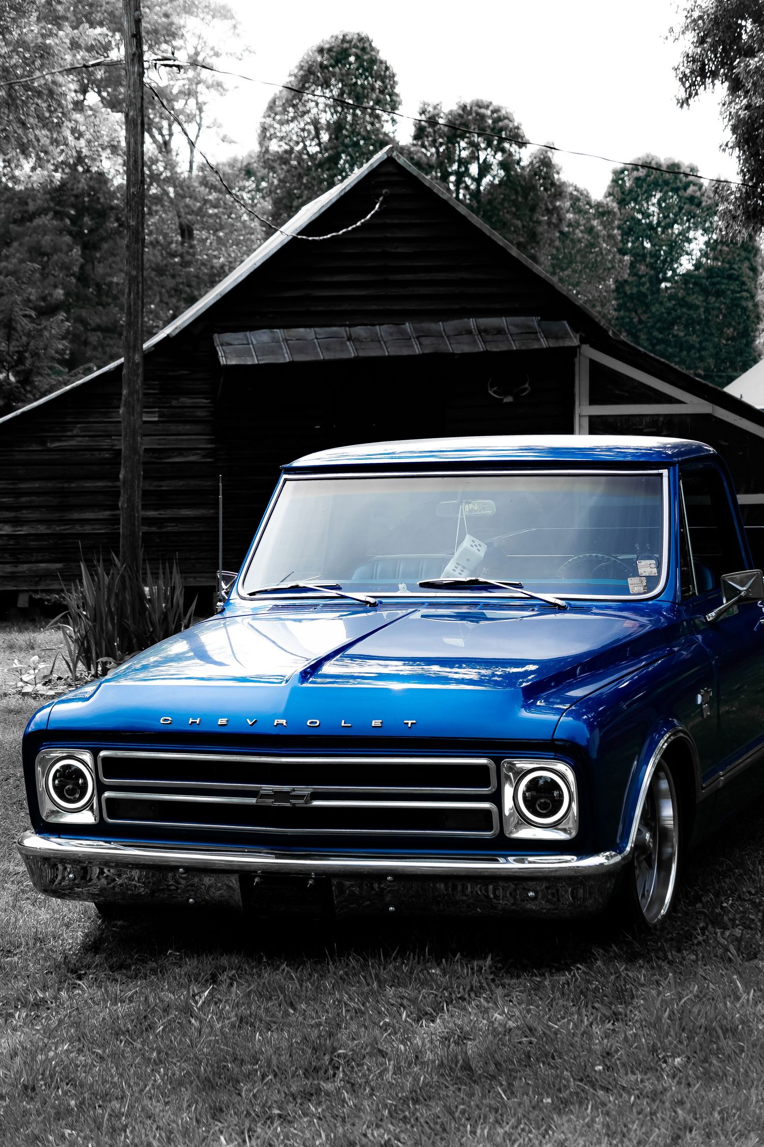 Classic blue Plymouth Barracuda shown from multiple angles against a rustic barn backdrop in black and white photos.