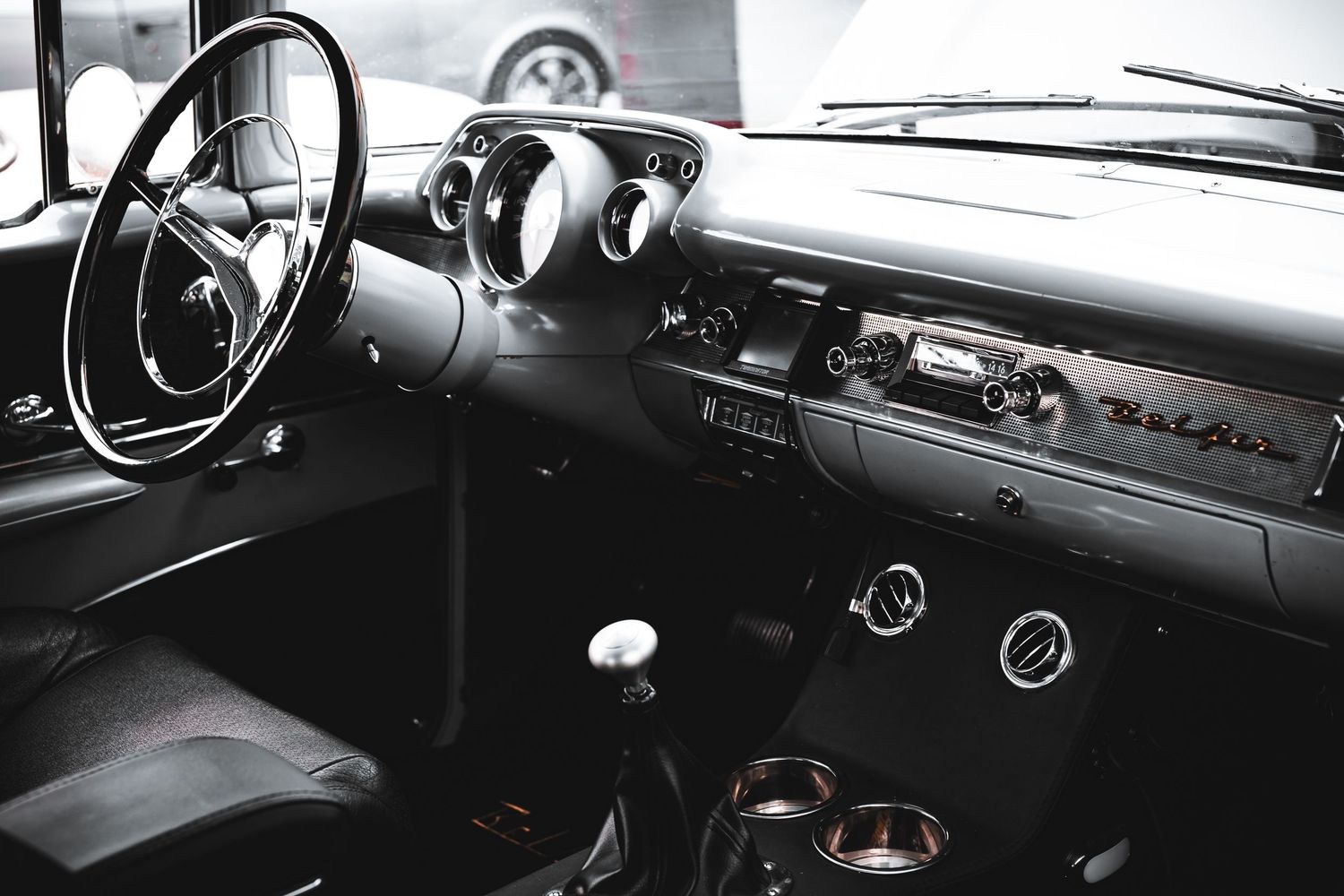 Black and white photo series showing vintage car dashboard details and interior controls from multiple angles.
