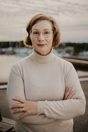 Portrait series of a person in a beige sweater with glasses showing different poses and expressions outdoors.