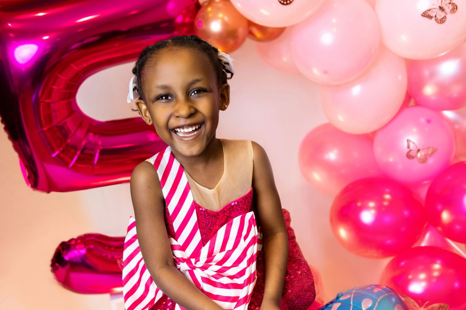 Festive birthday scene with pink and magenta balloons arranged around a number 5.