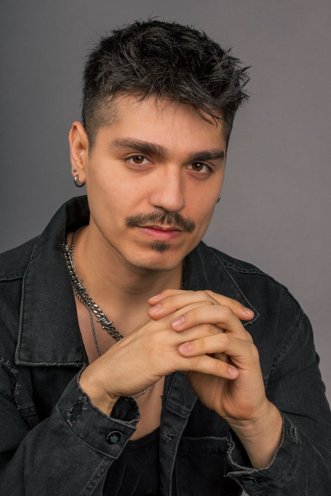 Artistic portrait series in black denim jacket showing contemplative poses against grey background.