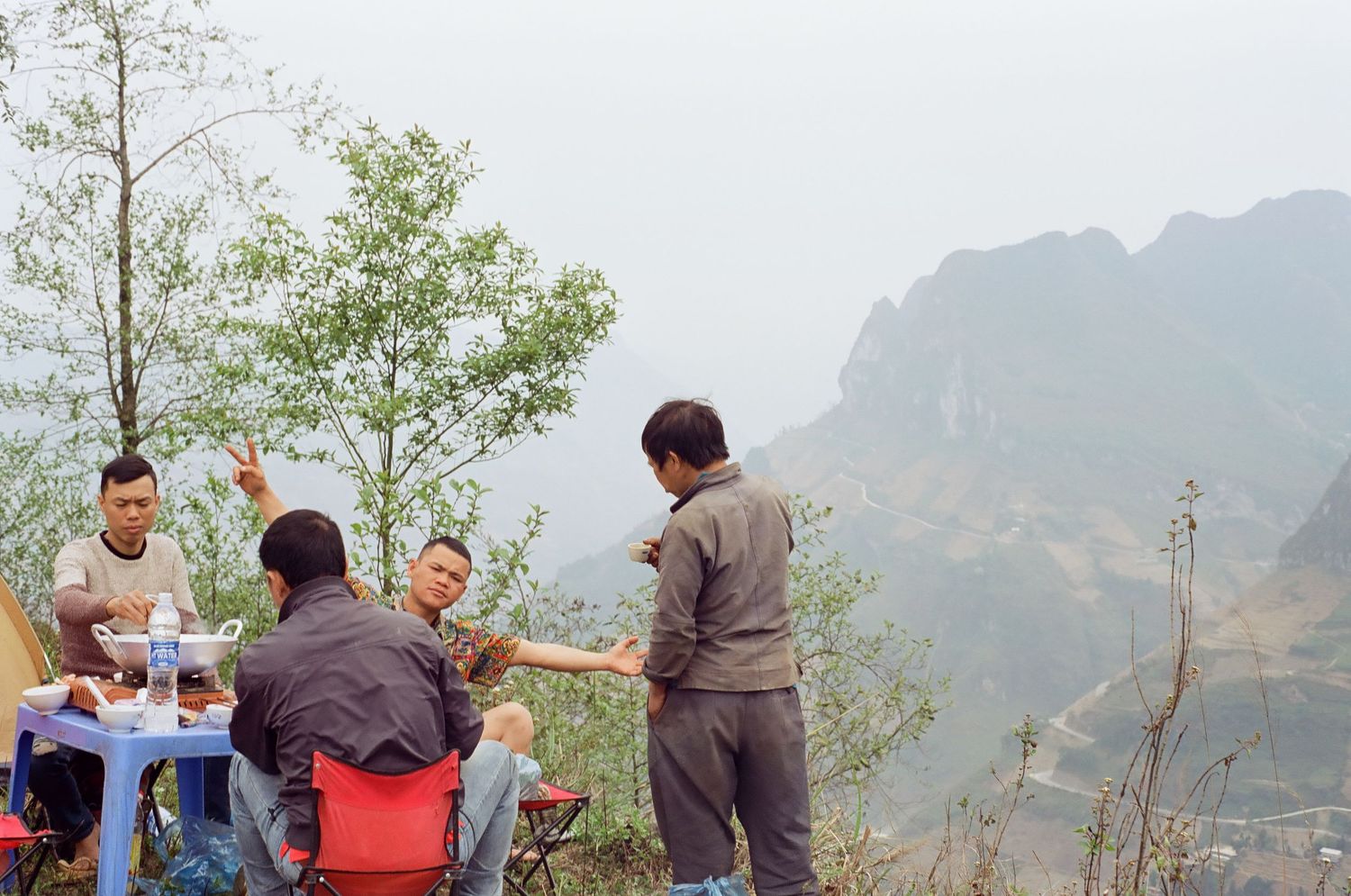 Group enjoying outdoor activities with mountain scenery in the background.