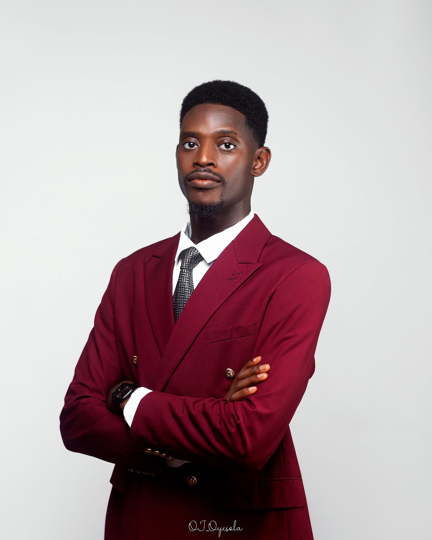 Professional headshot of Joshua with arms akimbo.