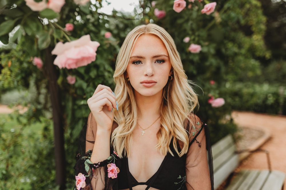 Portrait photos featuring pink roses and garden flowers in a lush outdoor setting.