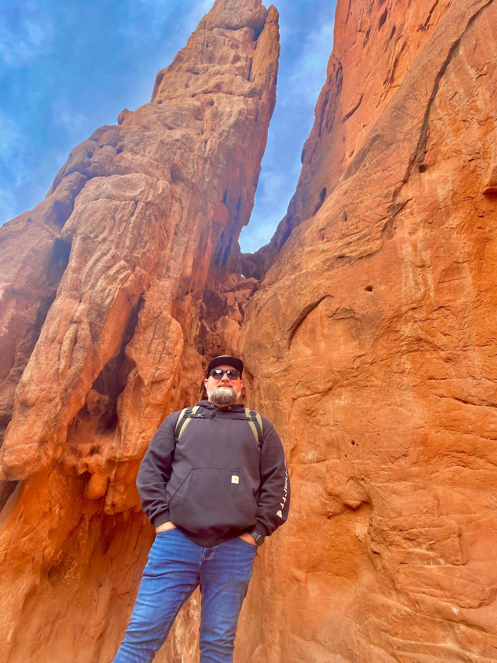 Red rock formations at Arches National Park with towering sandstone walls creating a natural corridor.