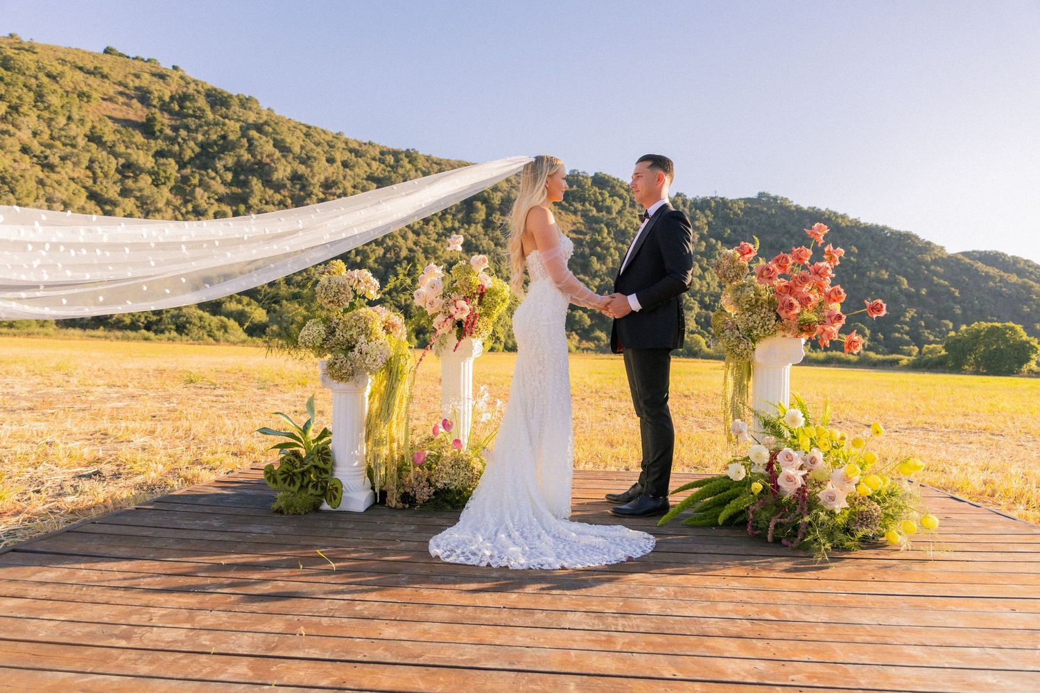 Intimate wedding portrait of couple sharing tender moment during sunset photoshoot.