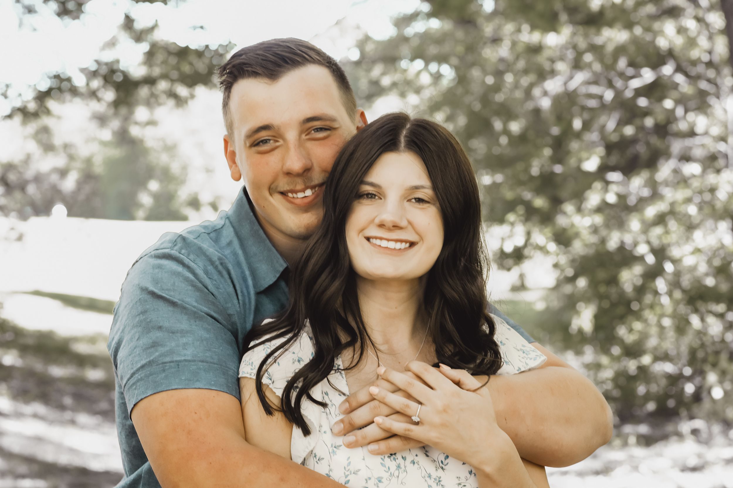 Happy couple shares intimate moment while embracing outdoors.