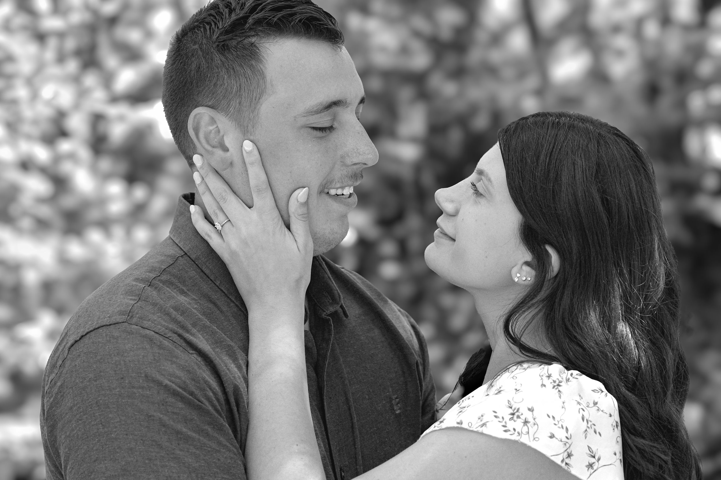 Couple in casual attire sharing affectionate moments outdoors.