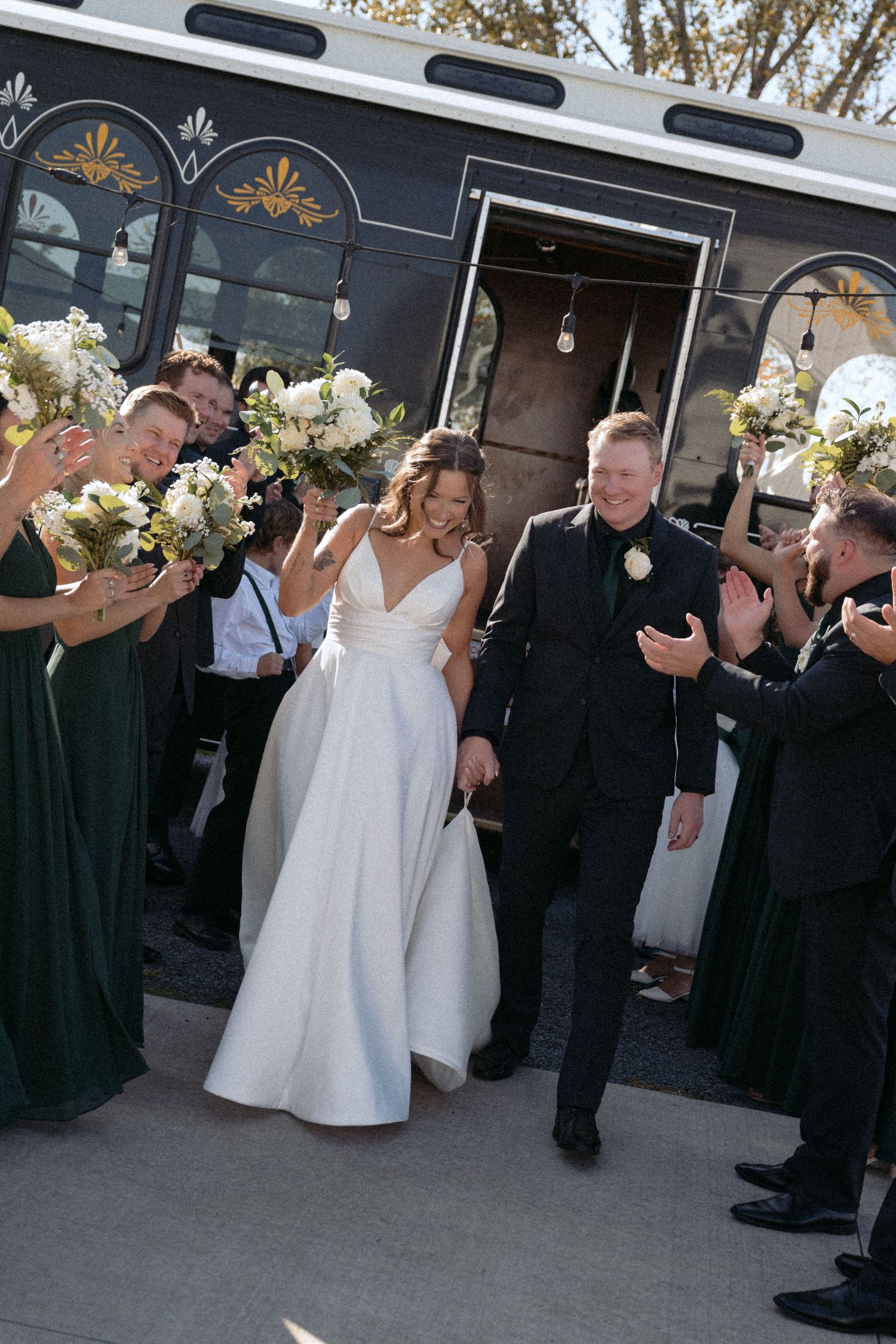 bride and groom step off their party bus and bridal party cheers at abella farms wedding in chisago city, mn