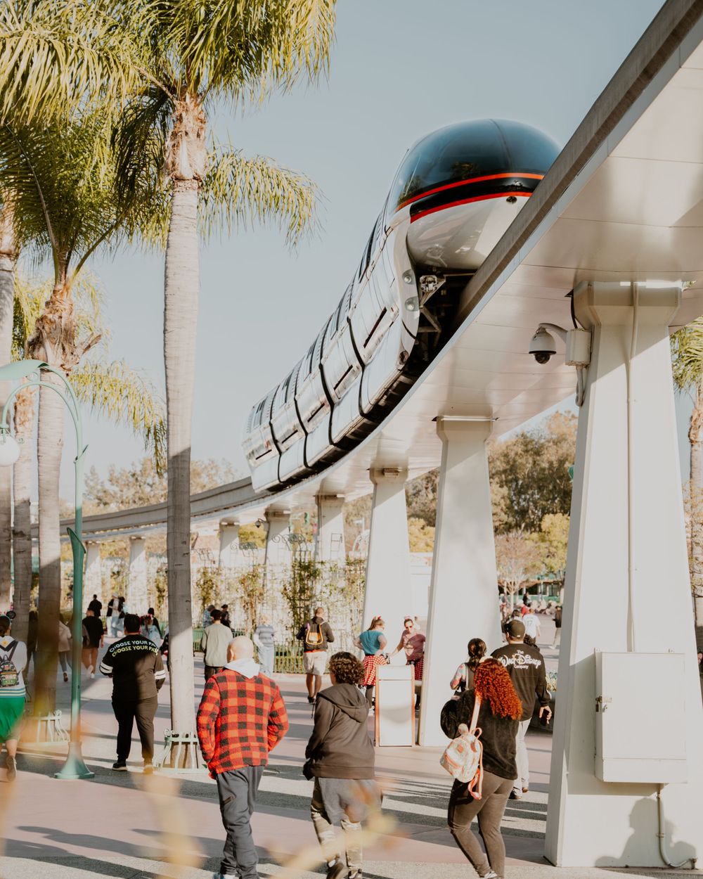Monorail and guests entering disneyland