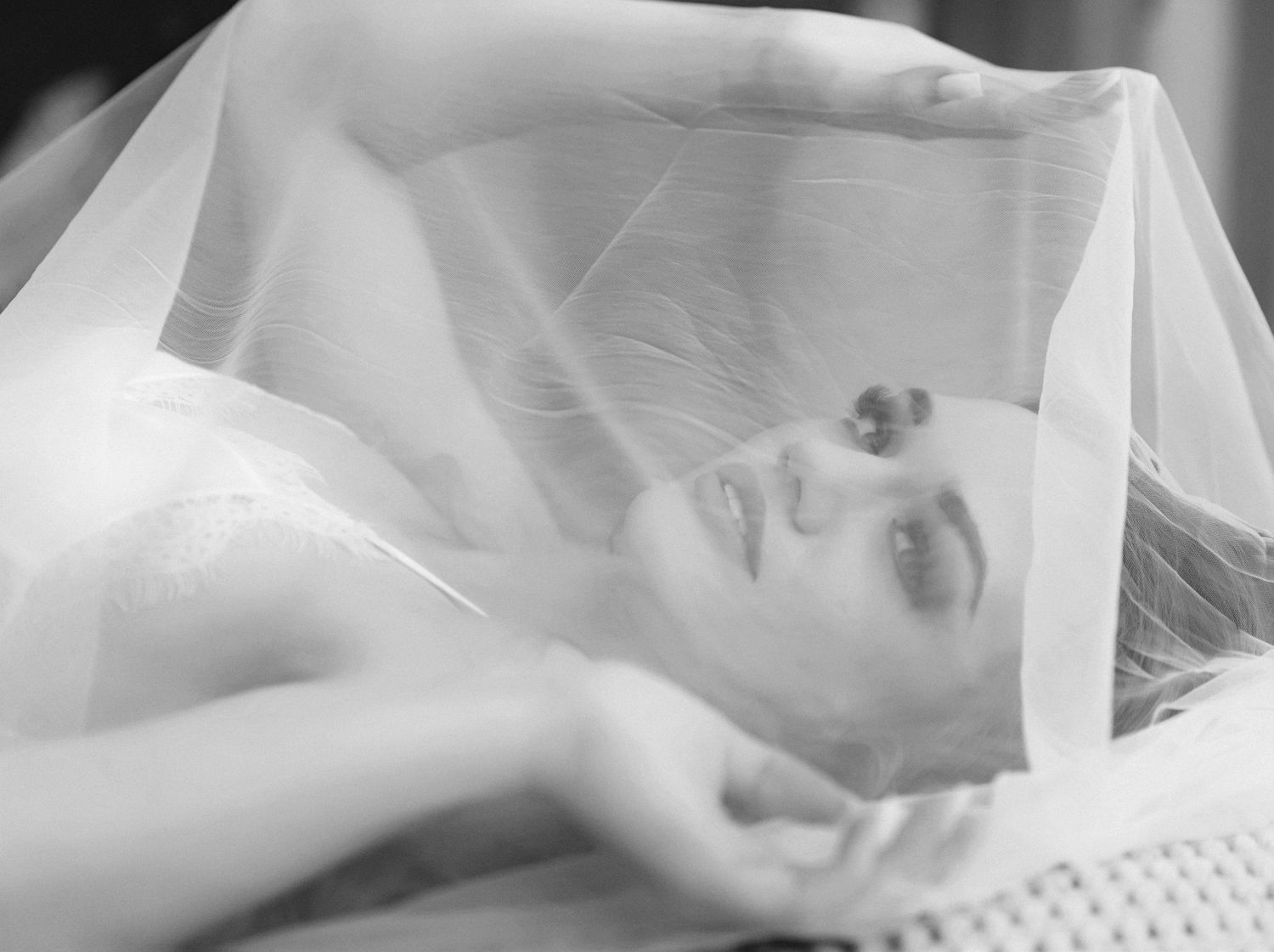 Soft boudoir photo series on textured white bedding in natural light. Columbus Ohio
