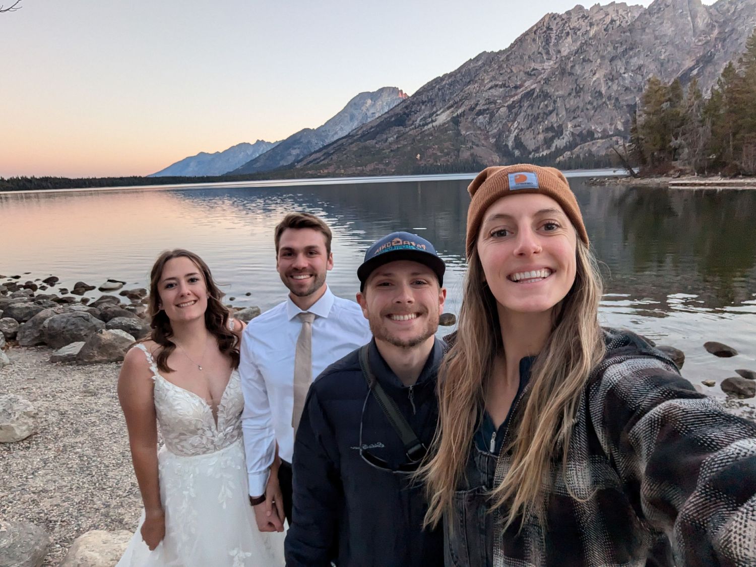 Group celebrates joyfully at wedding reception indoors.