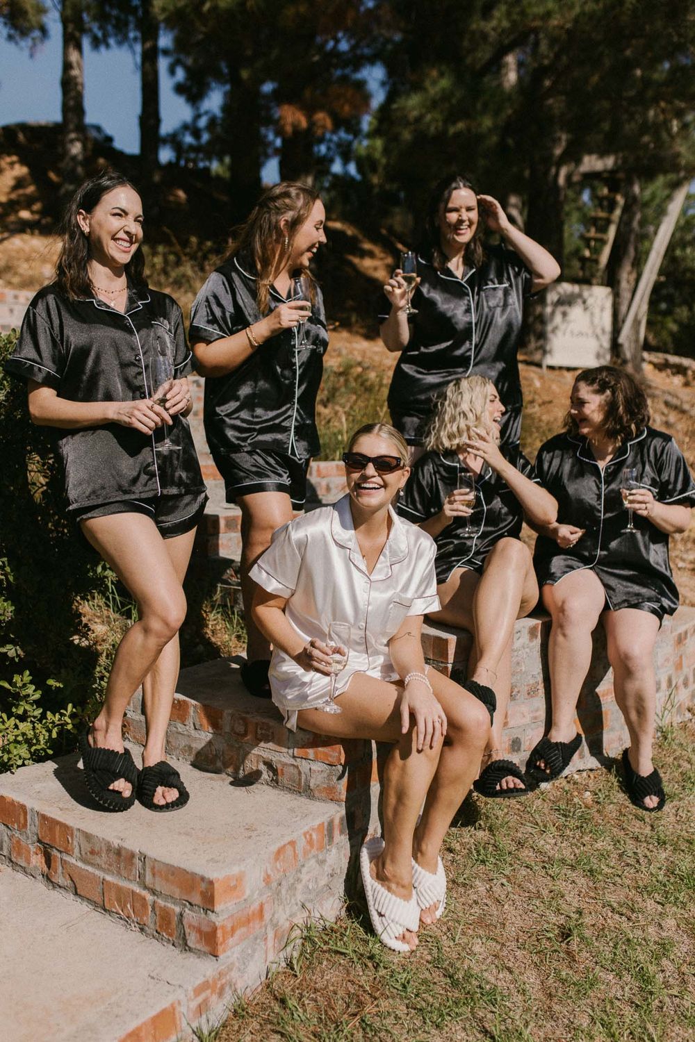 Candid bridesmaid moment while helping the bride get dressed — Cape Town wedding photographer capturing authentic emotion