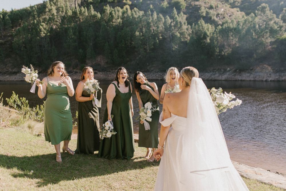 Candid bridesmaid moment while helping the bride get dressed — Cape Town wedding photographer capturing authentic emotion