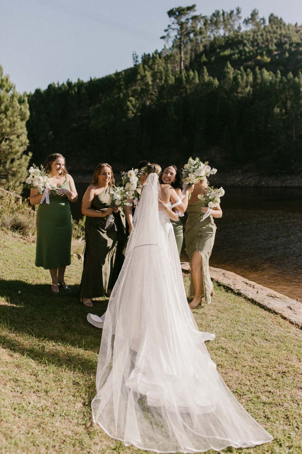 Candid bridesmaid moment while helping the bride get dressed — Cape Town wedding photographer capturing authentic emotion