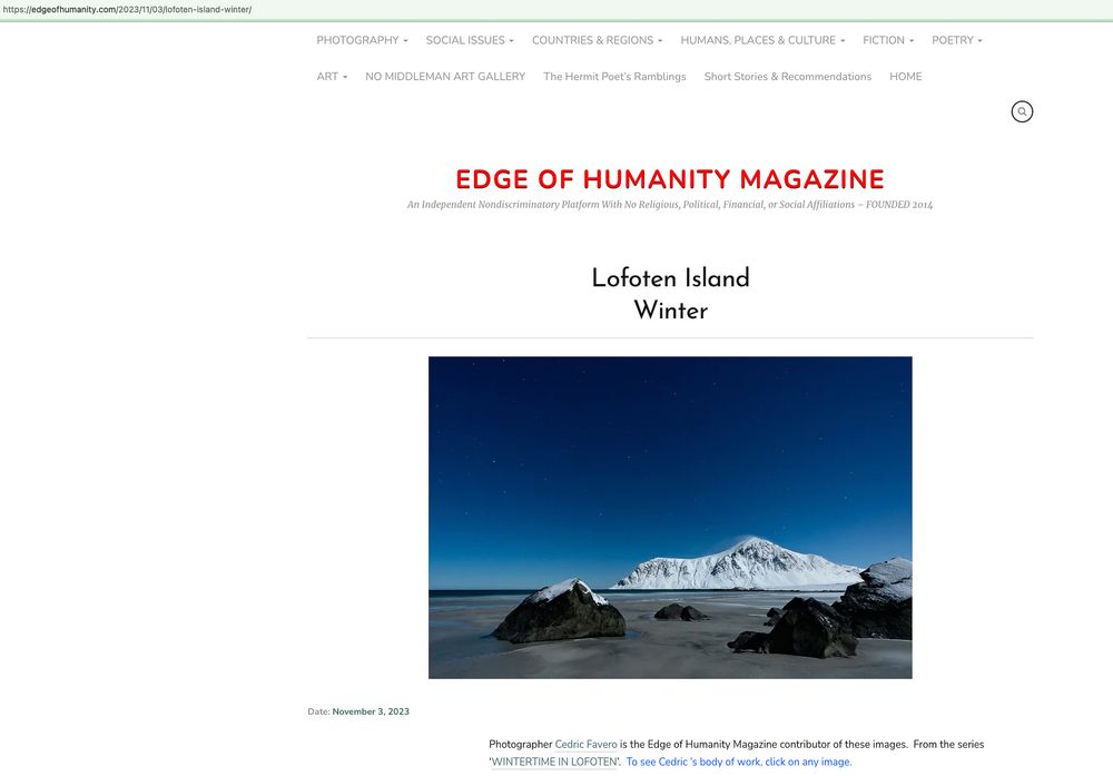 A snow-capped mountain peak rises against a deep blue sky on LaFerte Island, featured in Edge of Humanity Magazine.