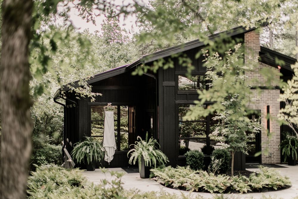 A rustic wooden cabin nestled among tall evergreen trees in a peaceful forest setting.