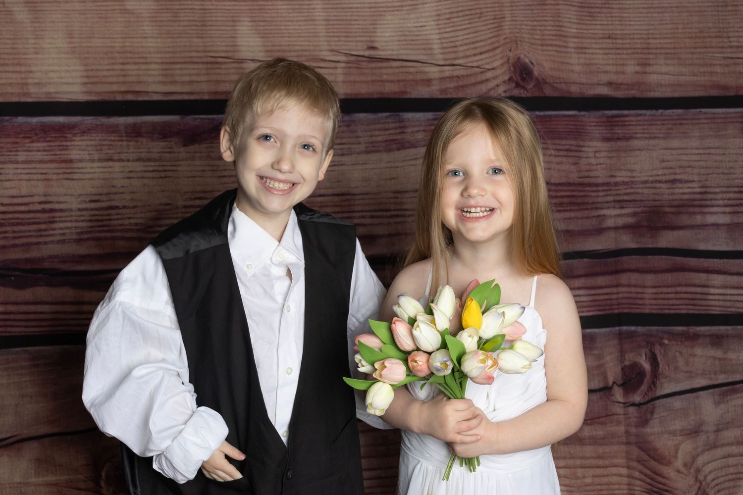 Boy in tux, girl in wedding dress posing for a portrait. Salem and Gloucester County Children Portraits