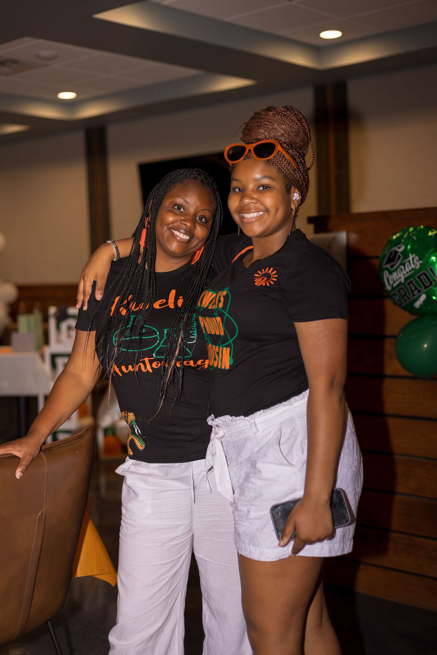 Friends in matching t-shirts sharing a moment at casual gathering.