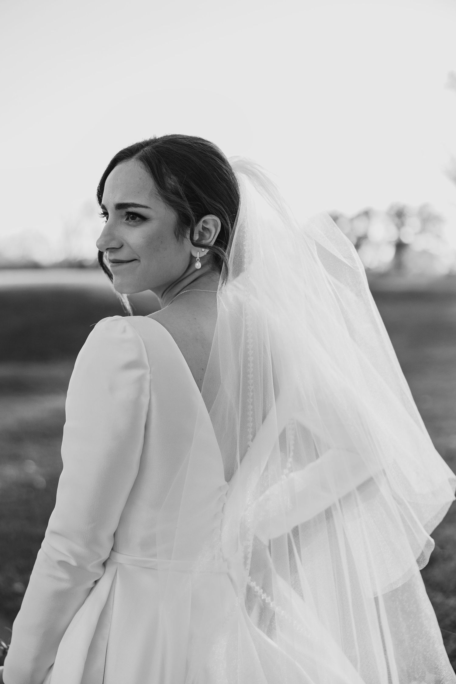 Groom kissing his bride's temple while she happily gazes at the camera at Briar Ridge Country Club in Schereville, Indiana.