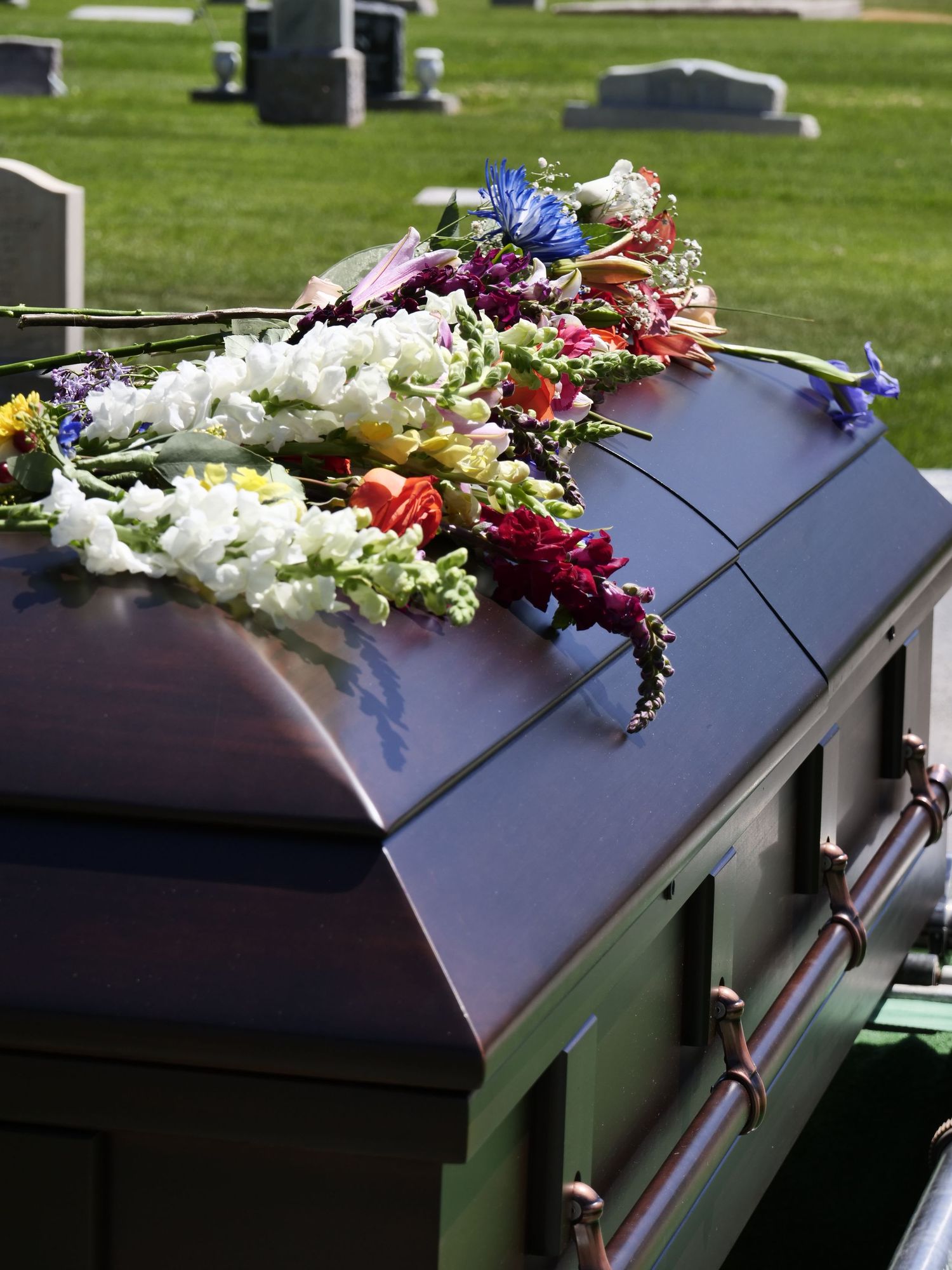 Flowers draping the casket at the end of the service
