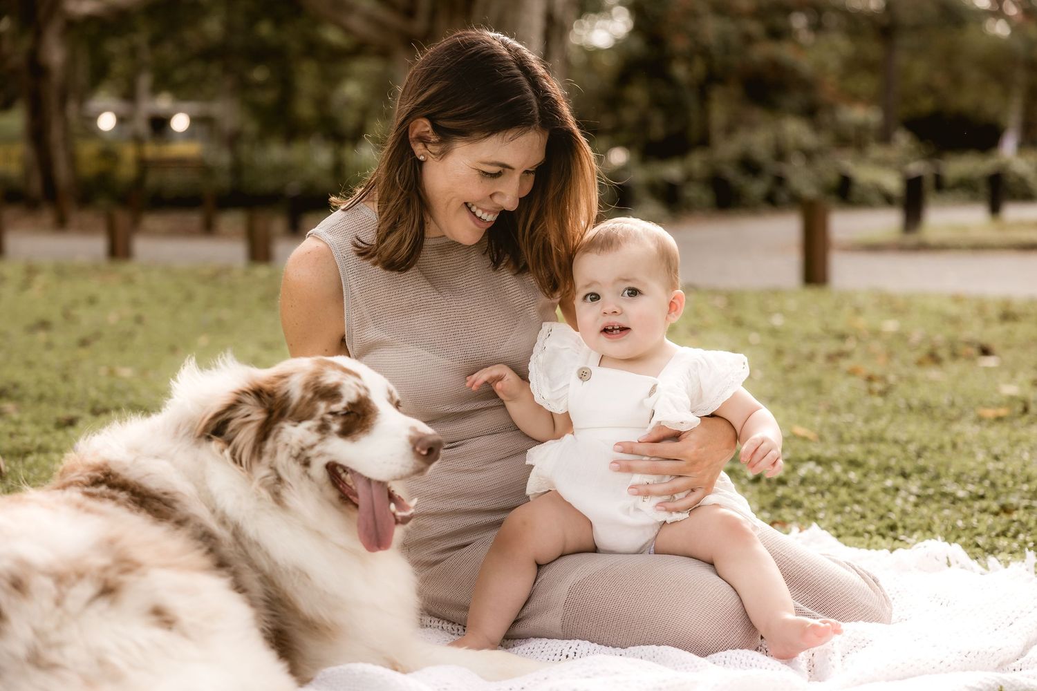 Mother and daughter on bed during an in-home baby portrait shoot
