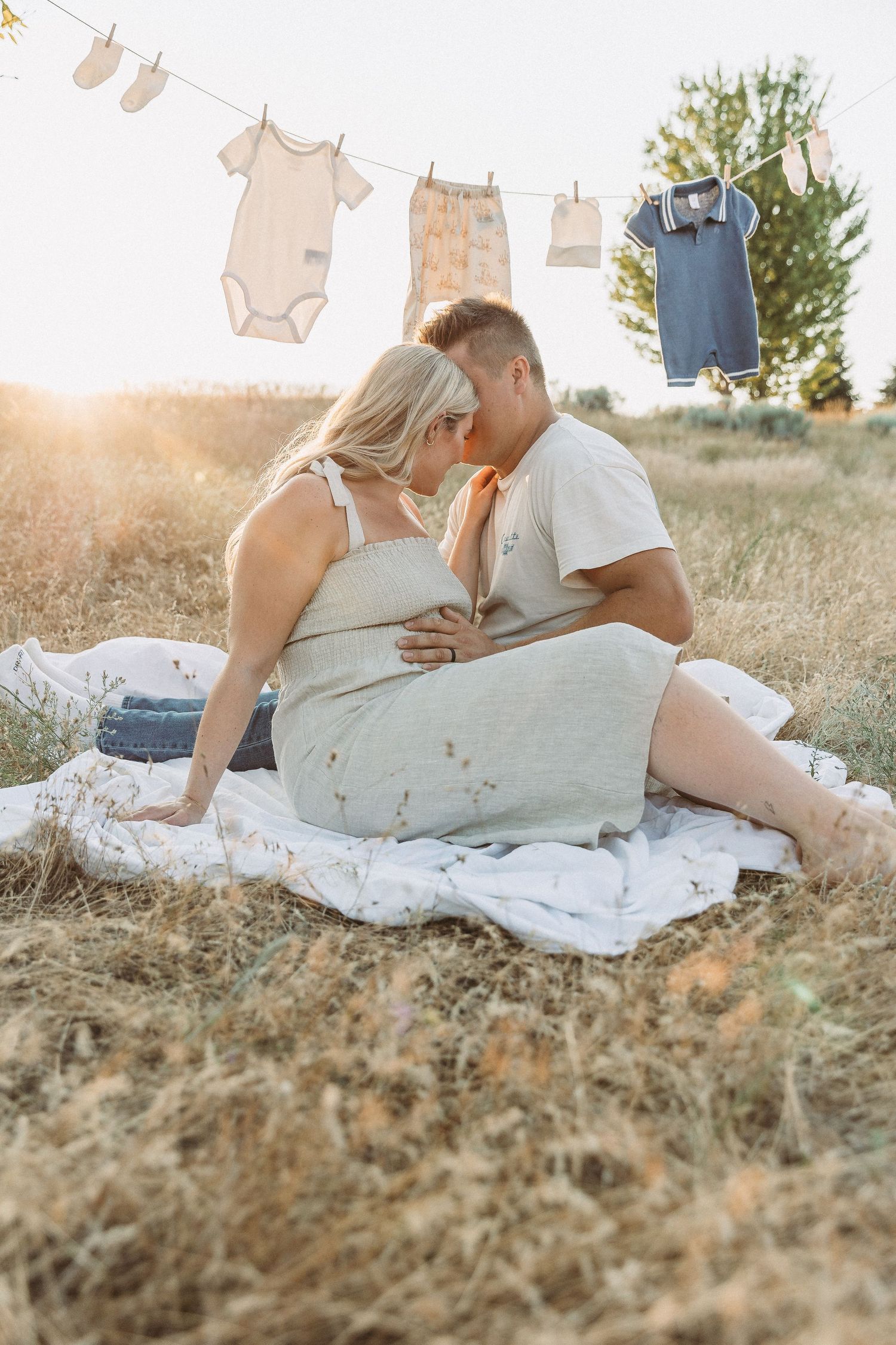 A romantic picnic setup with clothes hanging on a line during sunset.