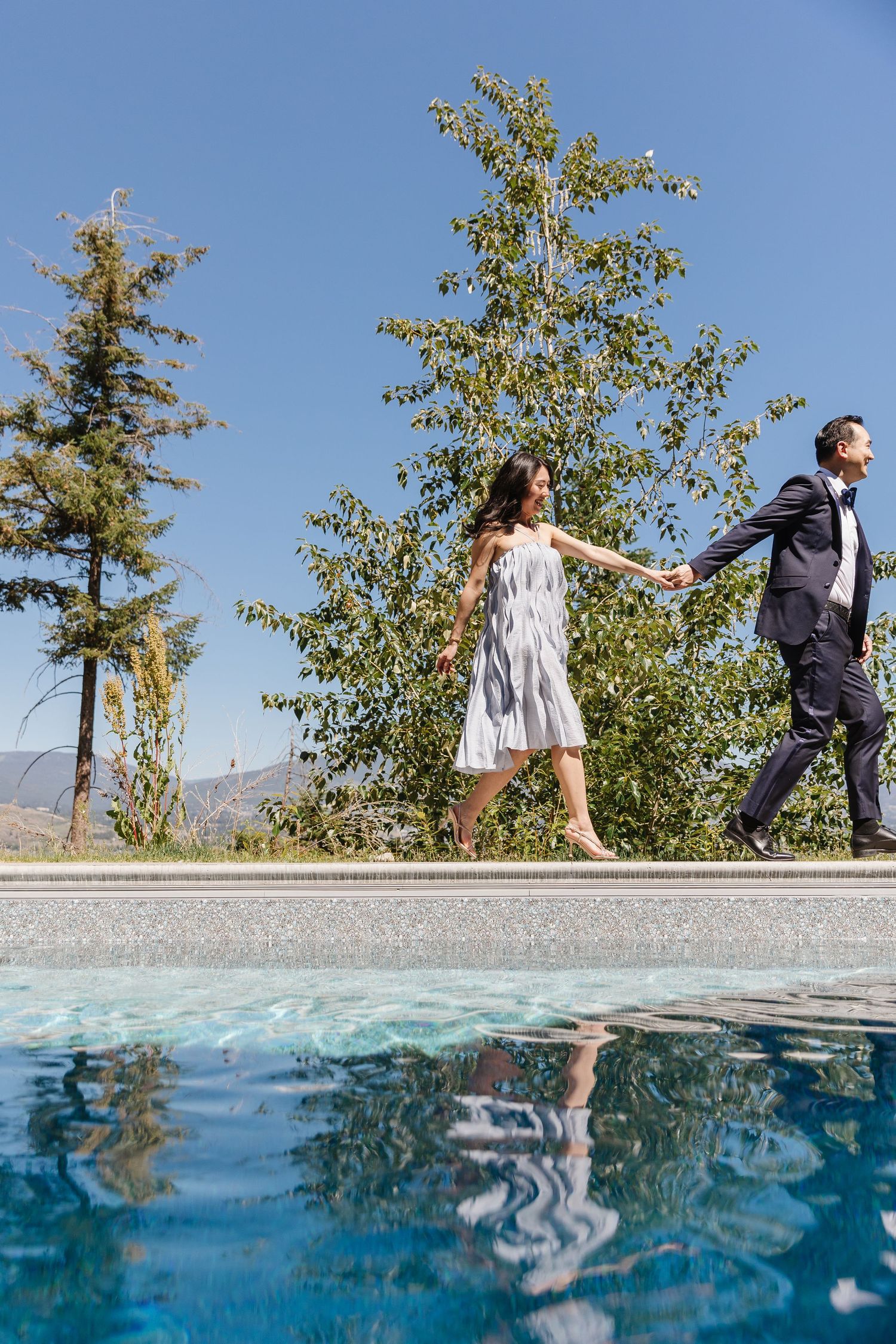 Split-level underwater and above water photo series showing couple walking on dock with trees in background.
