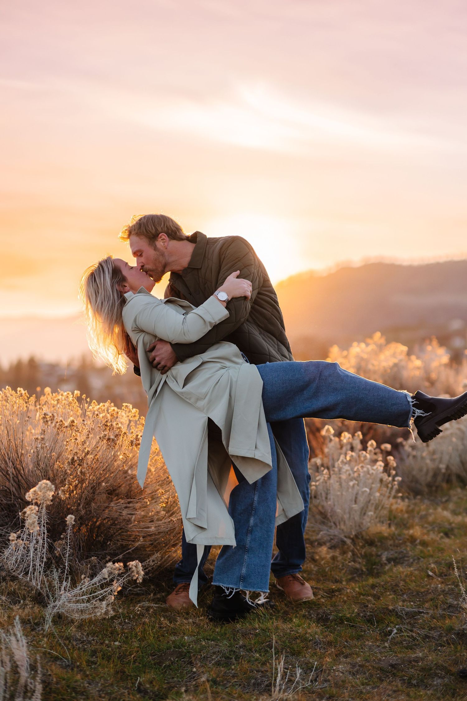 A romantic sunset photoshoot with a couple in a field of dried grass.