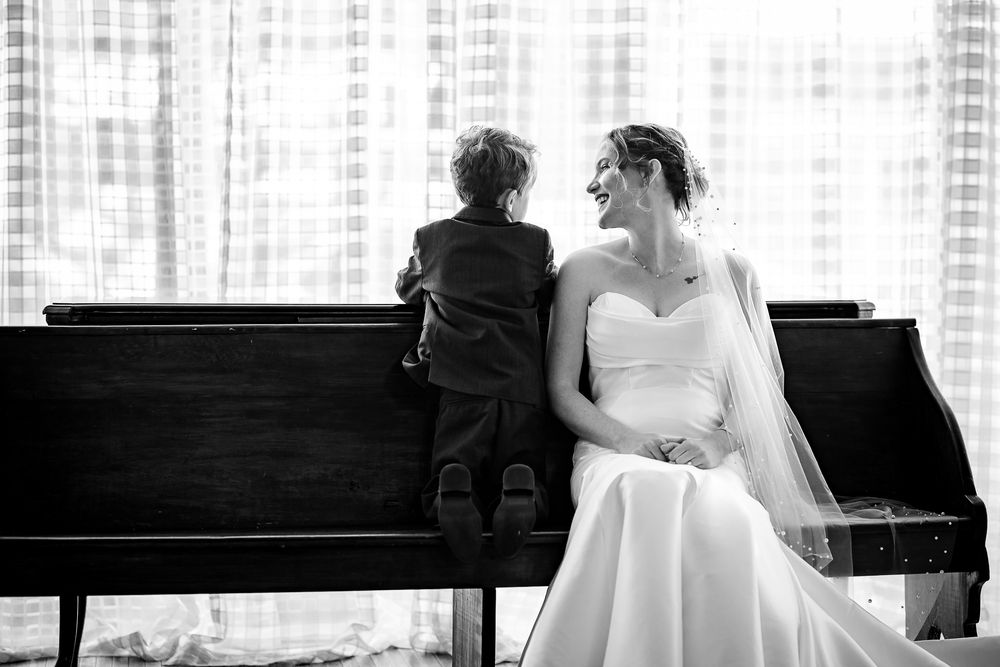 Black-and-white photo of a bride and her young son sharing a moment at a Springfield, Missouri wedding
