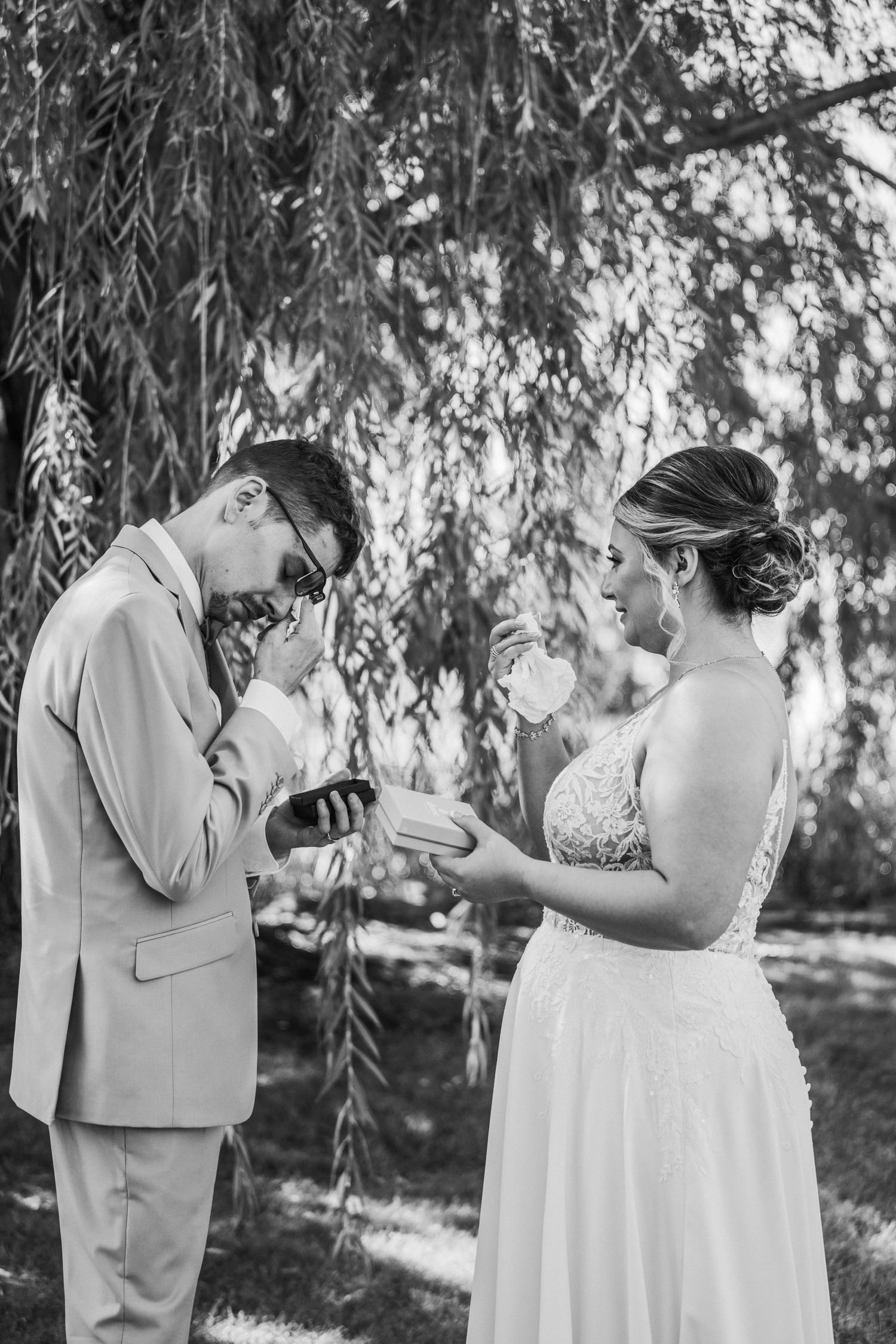 Wedding couple having an emotional first look and gift exchange. At the Rolling Ridge wedding venue in St Joseph MN.