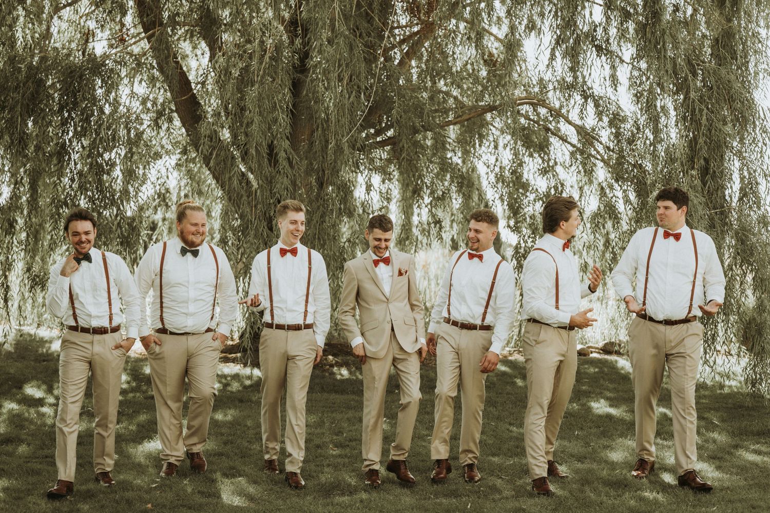 Groom and his groomsmen walking and enjoying their wedding day.