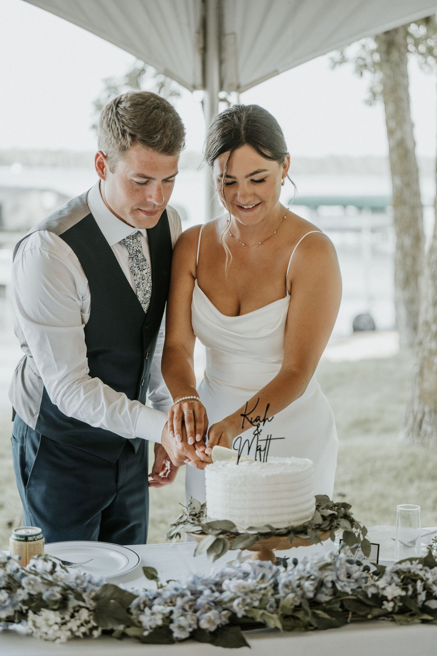 bride and groom cutting the wedding cake.