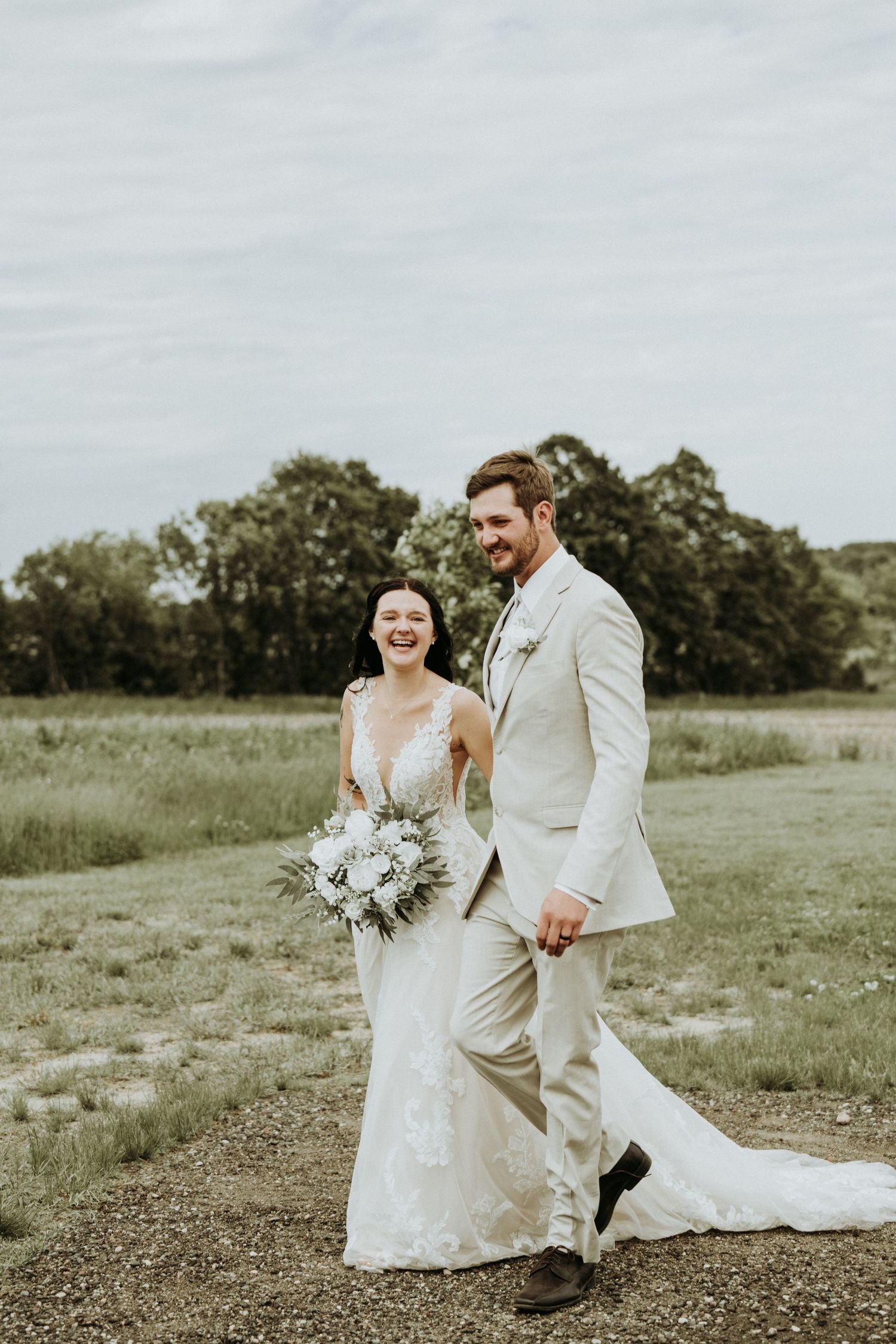 couple walking just after their wedding ceremony, Stone Hill Farm Eagle Bend MN.